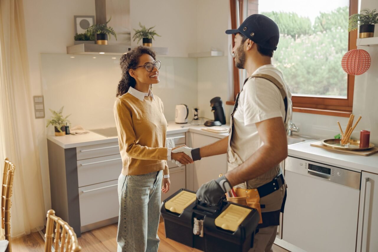 Licensed Plumber shaking hands with a woman in Manhattan.